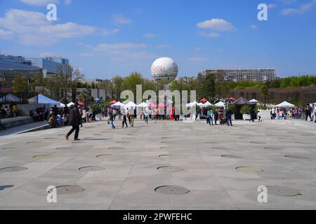 Paris, France - April 9, 2023 : White tents installed in the Parc André Citroën for a springtime special event on the left bank of Paris, under a hot Stock Photo