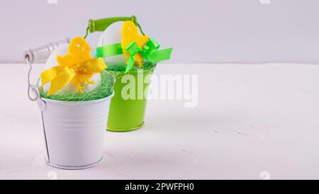 Easter decor with selective focus. Holiday still life with decorative eggs in a buckets with copy space for text Stock Photo