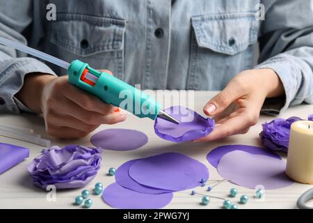 Woman make floral decor with melt glue gun Stock Photo - Alamy