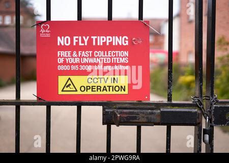 Red no fly tipping sign on metal gate Stock Photo