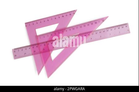 Plastic pink rulers isolated on white, top view Stock Photo