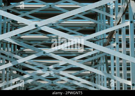 Looking up at metal pattern underneath bleachers Stock Photo