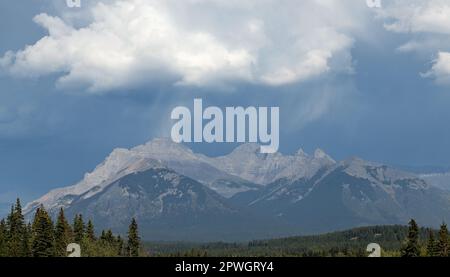 Thunder storm with rain falling on Rocky Mountains peaks, Banff national park, Canada. Stock Photo