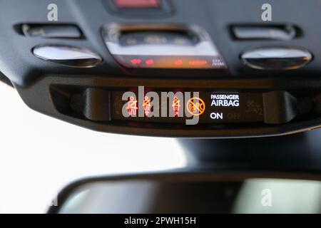 Seat belt and passenger airbag light showing on the car rear view mirror inside the car under the headlight. Signs inside the car. Selective focus. Stock Photo