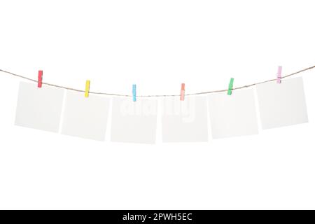 Clothespins with empty notepapers on string against white background. Space for text Stock Photo