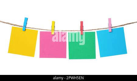 Clothespins with empty notepapers on string against white background. Space for text Stock Photo
