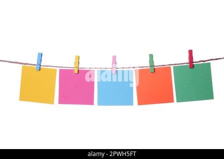 Clothespins with empty notepapers on string against white background. Space for text Stock Photo