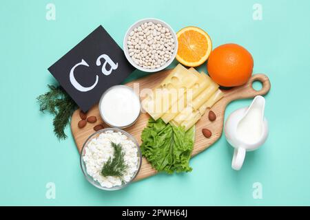 Food high in calcium. Flat lay composition with different products on turquoise background Stock Photo