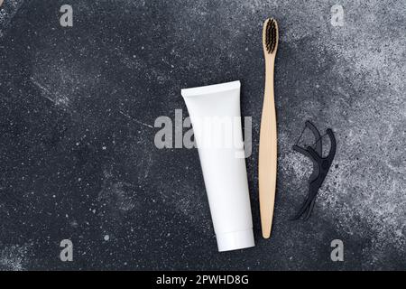 Oral care products. Toothbrush, paste and floss on a black background. Healthy smile concept Stock Photo
