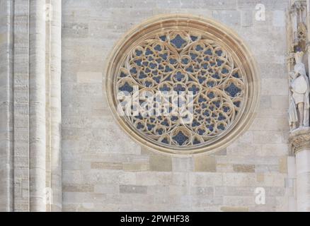 Gothic round window against the stone wall of St. Stephen's Cathedral in Vienna in horizontal format Stock Photo