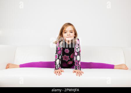Cute little girl making splits Stock Photo
