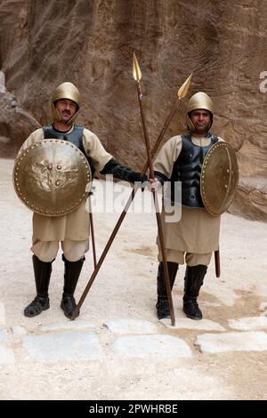 Two soldiers in ancient armour of the Nabataeans, at the entrance to the Siq, gorge, canyon, Archaeological Park Petra, Rock City Petra, Jordan, Asia Stock Photo