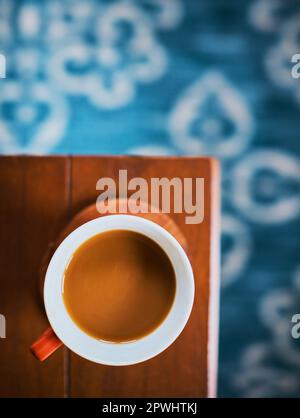 Calling all coffee lovers. High angle shot of a cup of coffee on a table. Stock Photo
