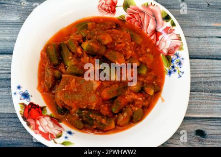 Okra cooked with beef meat pieces and tomato sauce, Bamia, bamya or Okro is Abelmoschus esculentus, known in many English-speaking countries as ladies Stock Photo