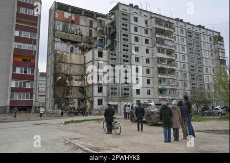 Uman, Ukraine. 30th Apr, 2023. People stand near destroyed house that was damaged as a result of a missile attack by the Russian army in Uman. On April 28, the Russian army launched massive missile strikes on Ukraine. As a result of the shelling of the city of Uman, a rocket hit a residential building. 23 people died, including 6 children. 19 people were injured. (Photo by Sergei Chuzavkov/SOPA Images/Sipa USA) Credit: Sipa USA/Alamy Live News Stock Photo