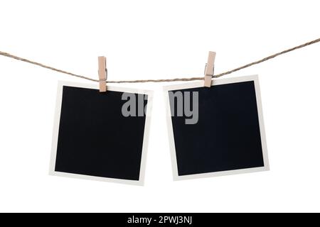 Clothespins with empty instant frames on string against white background. Space for text Stock Photo
