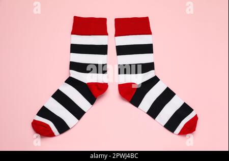 Striped socks on pink background, flat lay Stock Photo