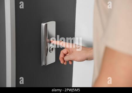 Man pressing elevator call button, closeup view Stock Photo