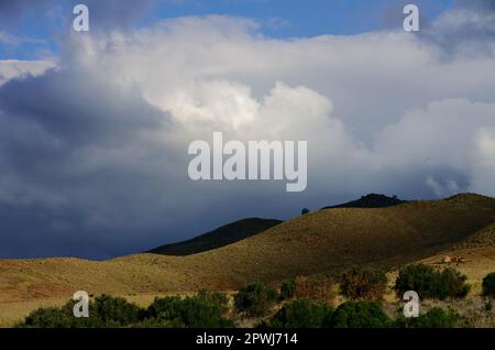 dramatic landscape with blue storm clouds on rural Sicily in a sunny and rainy day on spring, Italy Stock Photo