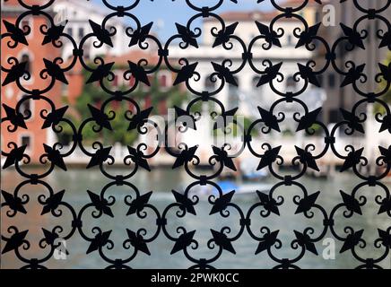 Detail of an ancient window with grating in wrought iron. Venice, Italy, Stock Photo