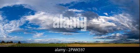 Dishevelled stratus clouds in the sky in a panoramic shot Stock Photo