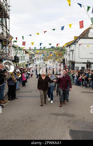 Helston, Cornwall, UK. 1st May, 2023. Helston May day parade, with the town Band and many people following the band round the street Credit: kathleen white/Alamy Live News Stock Photo