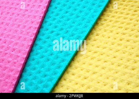 A set of cleaning wipes, microfiber cloths or sponges for the kitchen, three multi-colored cloths. Sponge fibers sponge texture pattern surface close- Stock Photo