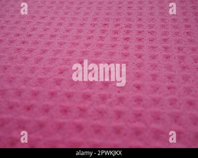 Sponge fibers sponge texture pattern surface close-up pink magenta background. Stock Photo