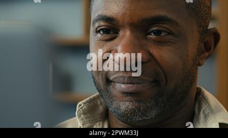 Portrait mature african american man looking laptop screen browsing email working online at home using computer close-up happy smiling male face Stock Photo