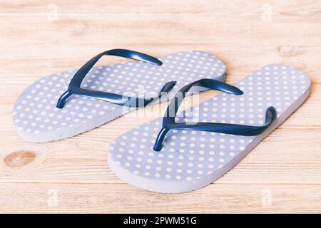 Beach accessories. Flip flops and starfish on colored background. Top view Mock up with copy space. Stock Photo
