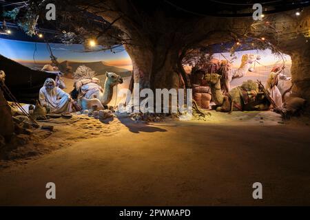 Camels resting and tribesmen making camp in the desert. Two dioramas depicting scenes from UAE's past, at the Abu Dhabi History Museum in the United A Stock Photo