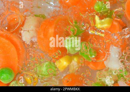 Close-up fresh soup vegetables with carrots, peas, cauliflower and corn on white background. Soup vegetables with carrots, peas, cauliflower and corn Stock Photo