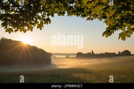 Panoramic landscape image of sunrise on a foggy morning during autumn, Bergisches Land, Germany Stock Photo