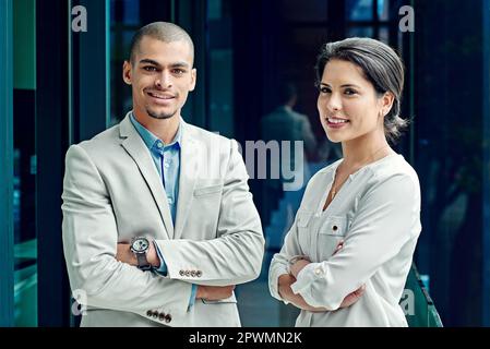 Passionate young professionals. Portrait of two young successful colleagues at work. Stock Photo