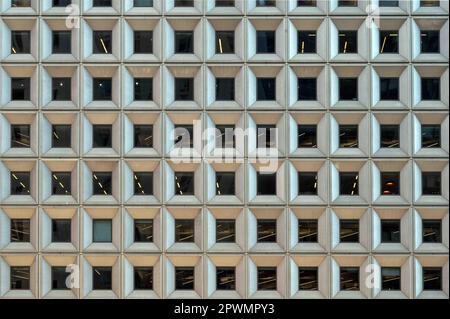 Facade of urban skyscraper rows of square geometric pattern windows Stock Photo