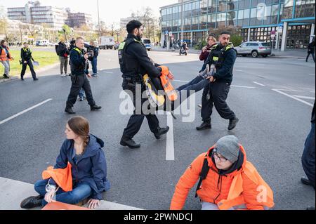 28.04.2023, Berlin, Germany, Europe - Climate protesters of so-called Last Generation (Letzte Generation) have glued themselves to asphalt of a road. Stock Photo