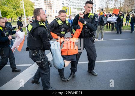 28.04.2023, Berlin, Germany, Europe - Climate protesters of so-called Last Generation (Letzte Generation) have glued themselves to asphalt of a road. Stock Photo