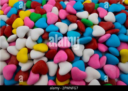 Background of multi-colored candies in the form of hearts (close-up) Stock Photo