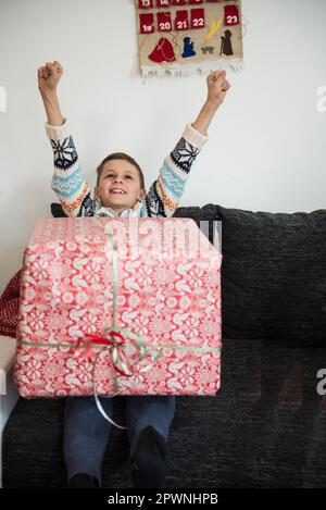 Cheerful boy with Christmas present Stock Photo