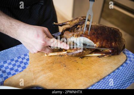 Cook carving a roasted duck Stock Photo