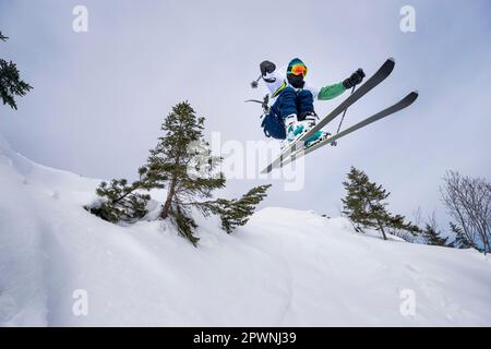 Man jumping with ski, Bavaria, Germany Stock Photo