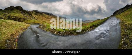 A panoramic view of Hardknott Pass between the two upper hairpin bends. It is the steepest road in England with inclines of 30%, Eskdale, Cumbria. Stock Photo