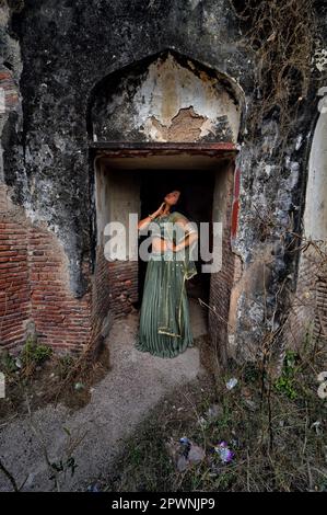 Nandini Singh, a female model poses for photos at the old fort near of the iconic Tajmahal. Stock Photo