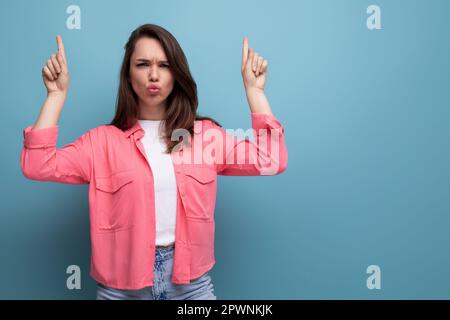 active emotional black-haired lady in casual style on studio background Stock Photo