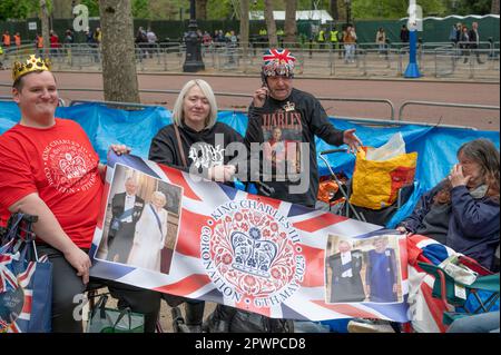 Westminster, London, UK. 1st May, 2023. Preparations continue along the route of the Coronation procession for King Charles III in central London, 5 days before the event. A small group of spectators are camping out overnight to grab a prime spot on The Mall to view the Coronation processions. Credit: Malcolm Park/Alamy Live News Stock Photo