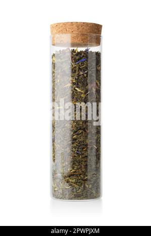 Glass jar with dry green tea isolated on white background. Stock Photo