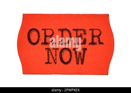 Order Now printed with typewriter font on red price tag sticker isolated on white background Stock Photo