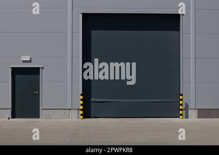 Roller shutter entrance to industrial loading area. Stock Photo