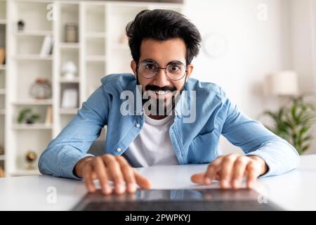 Pov Shot Of Excited Young Indian Man Using Laptop At Home Stock Photo