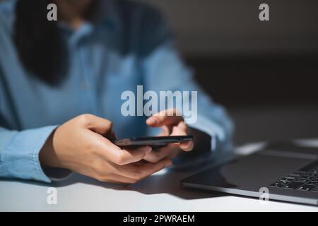 Close up of student hands using smart phone electronic learning. E-learning technology concept Stock Photo